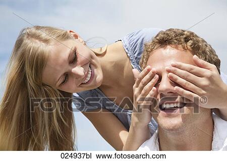 young couple playing peekaboo View Large Photo Image Stock Image - young couple playing peekaboo. Fotosearch