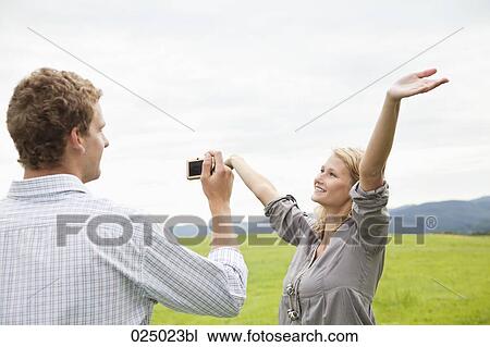 young man taking picture of young woman with digital camera View Large Photo Image Stock Image - young man taking picture of young woman with digital camera. Fotosearch