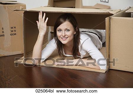 young woman lying in cardboard box View Large Photo Image Stock Image - young woman lying in cardboard box. Fotosearch