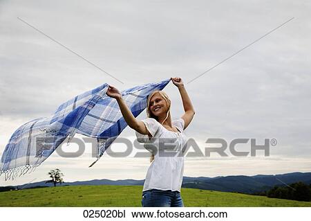 young woman waving cloth through the air View Large Photo Image Stock Image - young woman waving cloth through the air. Fotosearch
