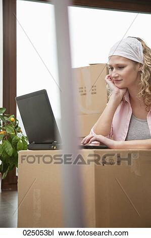 young woman with laptop computer in new home View Large Photo Image Stock Image - young woman with laptop computer in new home. Fotosearch