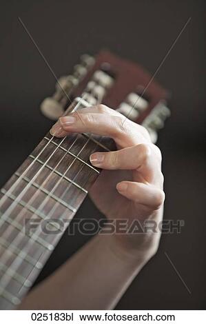 close-up of young woman playing guitar View Large Photo Image Stock Image - close-up of young woman playing guitar. Fotosearch