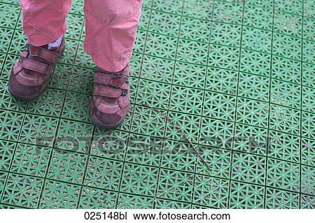detail of young child standing on green plastic mat View Large Photo Image Stock Image - detail of young child standing on green plastic mat. Fotosearch