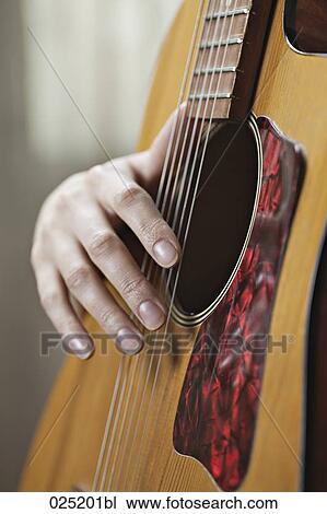 detail of young woman playing guitar View Large Photo Image Stock Image - detail of young woman playing guitar. Fotosearch