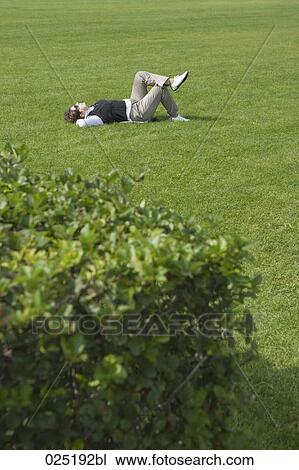 mature woman relaxing in grass View Large Photo Image Stock Image - mature woman relaxing in grass. Fotosearch