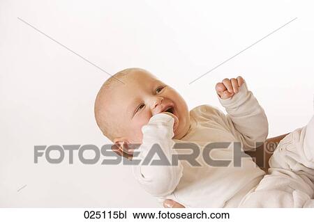 Stock Image - mother holding her baby. Fotosearch