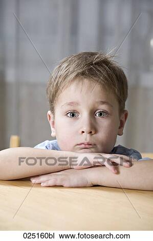 Stock Image - portrait of boy looking bored. Fotosearch