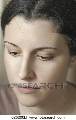 Stock Image - portrait of serious young woman. Fotosearch