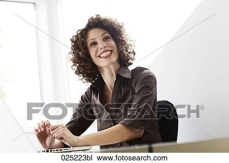 Stock Image - portrait of young businesswoman with laptop computer. Fotosearch
