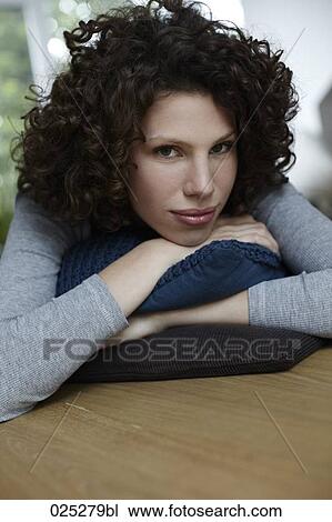 Stock Image - portrait of young woman at home. Fotosearch