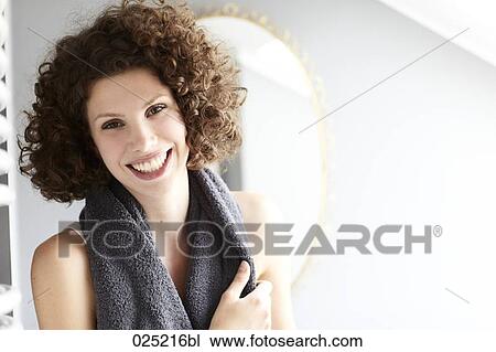 Stock Image - portrait of young woman in bathroom. Fotosearch