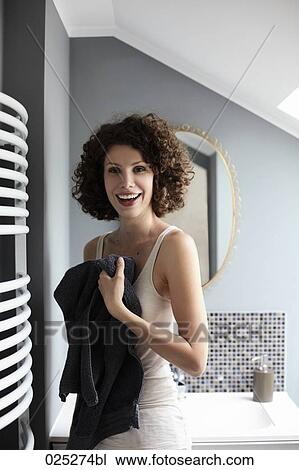 Stock Image - portrait of young woman in bathroom. Fotosearch