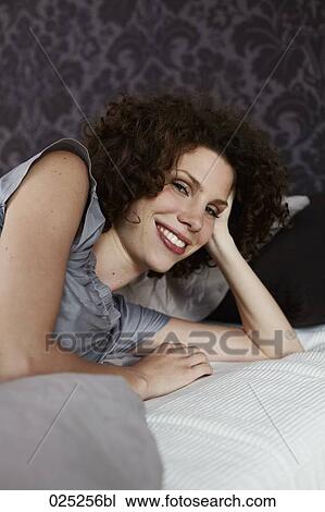 portrait of young woman in bed View Large Photo Image Stock Image - portrait of young woman in bed. Fotosearch