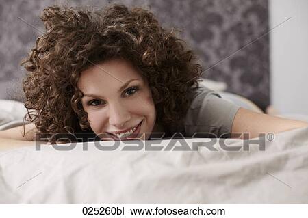 portrait of young woman in bed View Large Photo Image Stock Image - portrait of young woman in bed. Fotosearch