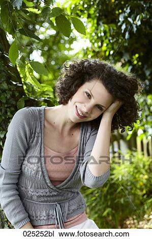 portrait of young woman in garden View Large Photo Image Stock Image - portrait of young woman in garden. Fotosearch