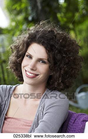 portrait of young woman sitting in garden View Large Photo Image Stock Image - portrait of young woman sitting in garden. Fotosearch