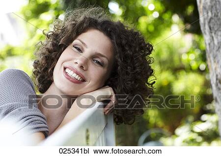 portrait of young woman sitting in garden View Large Photo Image Stock Image - portrait of young woman sitting in garden. Fotosearch
