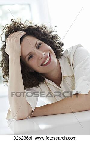 portrait of young woman with curly hair View Large Photo Image Stock Image - portrait of young woman with curly hair. Fotosearch