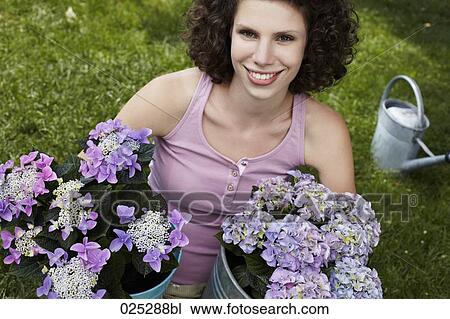 Stock Image - portrait of young woman with flowers. Fotosearch