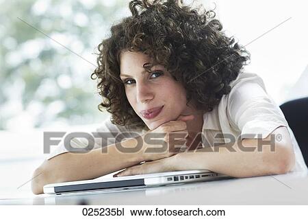 Stock Image - portrait of young woman with laptop computer. Fotosearch