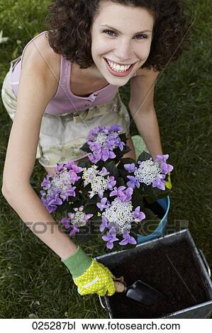 portrait of young woman working in garden View Large Photo Image Stock Image - portrait of young woman working in garden. Fotosearch