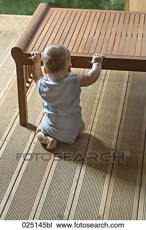 rear view of baby sitting in front of table View Large Photo Image Stock Image - rear view of baby sitting in front of table. Fotosearch