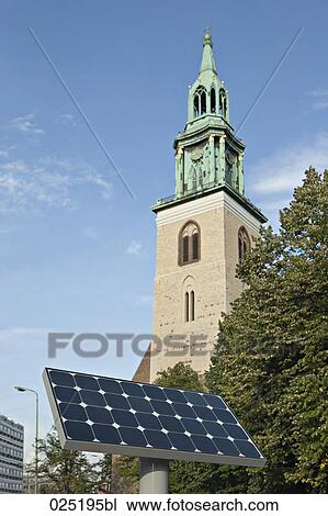 Stock Image - solar panel in front of church. Fotosearch