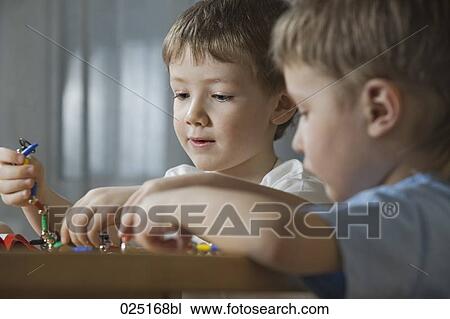 young boys playing with shape game View Large Photo Image Stock Image - young boys playing with shape game. Fotosearch