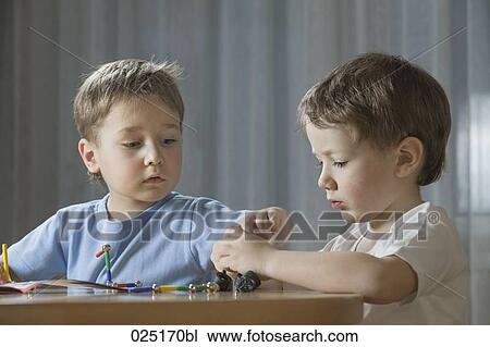 young boys playing with shape game View Large Photo Image Stock Image - young boys playing with shape game. Fotosearch