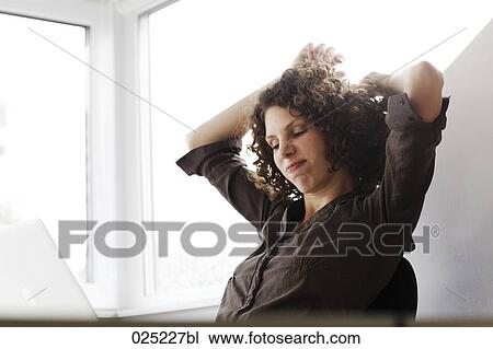 young businesswoman looking at computer View Large Photo Image Stock Image - young businesswoman looking at computer. Fotosearch