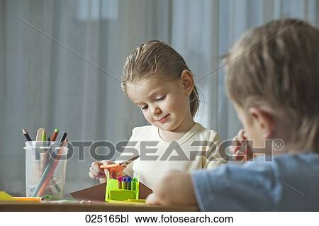 young girl and young boy doing handicraft together View Large Photo Image Stock Image - young girl and young boy doing handicraft together. Fotosearch