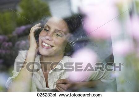 young woman listening to music View Large Photo Image Stock Image - young woman listening to music. Fotosearch