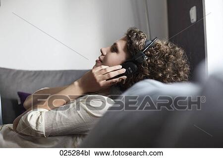 young woman listening to music View Large Photo Image Stock Image - young woman listening to music. Fotosearch