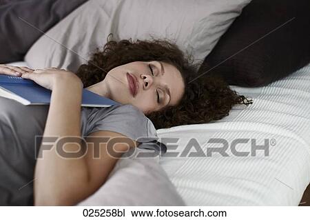 young woman lying in bed sleeping View Large Photo Image Stock Image - young woman lying in bed sleeping. Fotosearch
