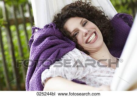 young woman lying in hammock in the garden View Large Photo Image Stock Image - young woman lying in hammock in the garden. Fotosearch