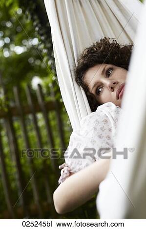 young woman lying in hammock in the garden View Large Photo Image Stock Image - young woman lying in hammock in the garden. Fotosearch