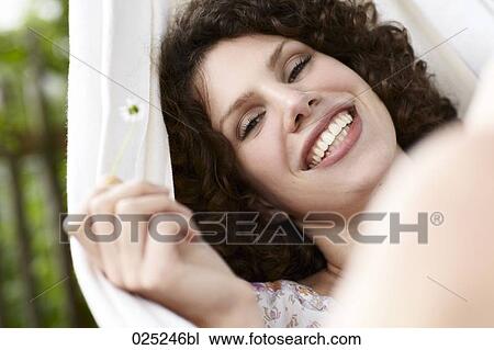 young woman lying in hammock in the garden View Large Photo Image Stock Image - young woman lying in hammock in the garden. Fotosearch