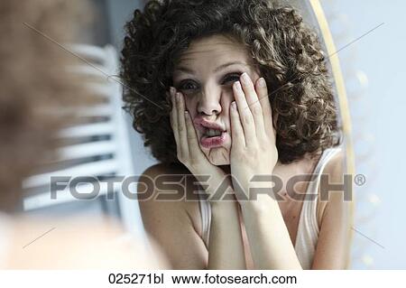 young woman shocked by her reflection in the mirror View Large Photo Image Stock Image - young woman shocked by her reflection in the mirror. Fotosearch
