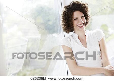 young woman standing by the window View Large Photo Image Stock Image - young woman standing by the window. Fotosearch