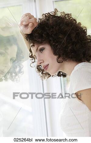 young woman standing by the window View Large Photo Image Stock Image - young woman standing by the window. Fotosearch