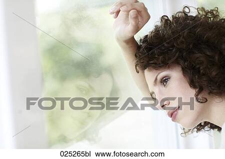 young woman standing by the window View Large Photo Image Stock Image - young woman standing by the window. Fotosearch