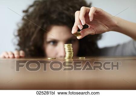young woman with pile of coins View Large Photo Image Stock Image - young woman with pile of coins. Fotosearch