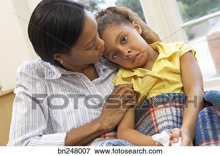 Mother Comforting Sick Daughter Stock Photo Bn248007 Fotosearch