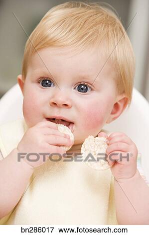 baby eating rice