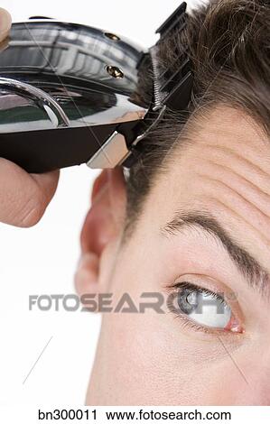 Man Cutting Hair With Clippers Stock Image Bn300011 Fotosearch