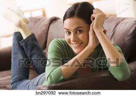 Smiling Woman Lying Down On Couch Stock Image Bn297092 Fotosearch