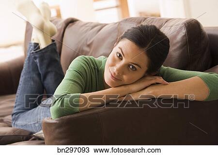 Smiling Woman Lying Down On Couch Stock Image Bn297093 Fotosearch