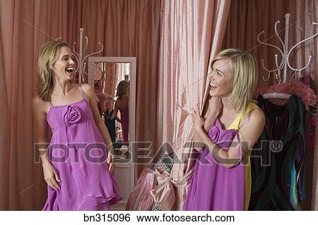 Stock Images Of Women Trying On Dresses In Ing Room Bn315096 Stock Image Women Trying On Dresses In Ing Room Fotosearch Search Photography