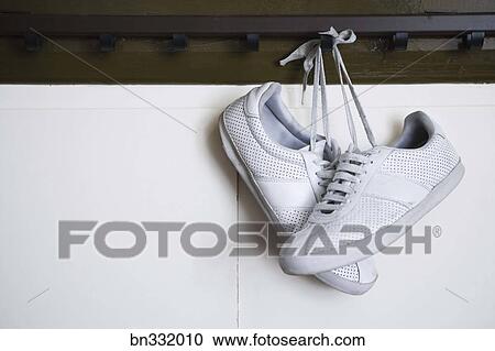 Tennis Shoes Hanging From Locker Room Peg Stock Image
