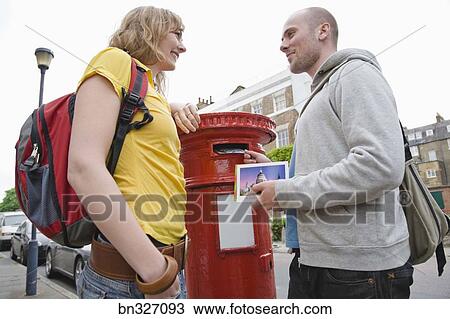 Stock Photo Of Couple Mailing Letter In Mailbox London England